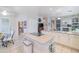 Island kitchen with cooktop, white cabinets, and breakfast bar at 5287 W Quail Ave, Glendale, AZ 85308