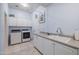 Bright laundry room with washer, dryer, and cabinets at 5287 W Quail Ave, Glendale, AZ 85308