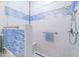 Spa-like shower with blue tile and glass enclosure at 5287 W Quail Ave, Glendale, AZ 85308