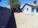 Large backyard with gravel landscaping, a tree, and a block wall for privacy at 5843 W Crocus Dr, Glendale, AZ 85306