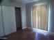 Well-lit bedroom with tile floor and closet at 5843 W Crocus Dr, Glendale, AZ 85306