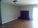 Living room fireplace with black tile surround at 5843 W Crocus Dr, Glendale, AZ 85306