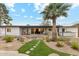 Pathway to a home with a sprawling backyard, featuring a covered patio and a palm tree at 5960 E Pershing Ave, Scottsdale, AZ 85254