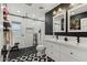 Modern bathroom with double vanity, walk-in shower, and geometric tile floor at 5960 E Pershing Ave, Scottsdale, AZ 85254