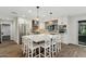 Modern kitchen with white cabinets, large island, and brick backsplash at 5960 E Pershing Ave, Scottsdale, AZ 85254