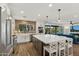 Modern kitchen with white cabinets, large island, and brick backsplash at 5960 E Pershing Ave, Scottsdale, AZ 85254