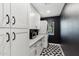 Laundry room with white cabinets and geometric tile floor at 5960 E Pershing Ave, Scottsdale, AZ 85254