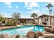 Inviting swimming pool with a rock waterfall feature at 5960 E Pershing Ave, Scottsdale, AZ 85254