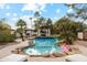 Stunning pool with a rock design and inflatable flamingos at 5960 E Pershing Ave, Scottsdale, AZ 85254