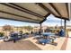 Covered outdoor dining area with grills and tables at 646 S Jacana Ln, Gilbert, AZ 85296