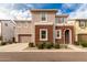 Two-story home with brick and stucco exterior, attached garage, and landscaping at 646 S Jacana Ln, Gilbert, AZ 85296