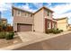 Rear view of the house showcasing garage and landscaping at 646 S Jacana Ln, Gilbert, AZ 85296