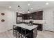 Modern kitchen featuring dark cabinetry, stainless steel appliances, and an island at 646 S Jacana Ln, Gilbert, AZ 85296