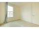 Well-lit bedroom with window, carpet, and neutral walls at 6850 E Mcdowell Rd # 7, Scottsdale, AZ 85257