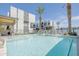 Stunning community pool and spa with modern building in the background at 6850 E Mcdowell Rd # 7, Scottsdale, AZ 85257