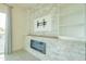 Living room with a modern fireplace and built-in shelving at 6850 E Mcdowell Rd # 7, Scottsdale, AZ 85257