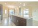 Large kitchen island with white quartz countertop and modern pendant lighting at 6850 E Mcdowell Rd # 7, Scottsdale, AZ 85257