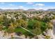 Neighborhood view with a lush green park and mountains in the distance at 7167 W Trails Dr, Glendale, AZ 85308