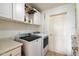 Functional laundry room with washer, dryer, and storage at 7167 W Trails Dr, Glendale, AZ 85308