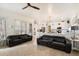 Open living room with black leather sofas and view into kitchen at 7167 W Trails Dr, Glendale, AZ 85308