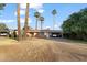 Front view of ranch home with palm trees and a spacious yard at 7329 N 16Th Ave, Phoenix, AZ 85021