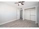 Bright bedroom with ceiling fan and mirrored closet doors at 7736 W Acoma Dr, Peoria, AZ 85381