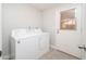 Bright laundry room with washer, dryer, and exterior access at 7736 W Acoma Dr, Peoria, AZ 85381