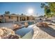 Stunning pool with rock features and home view at 7736 W Acoma Dr, Peoria, AZ 85381