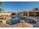 Inviting backyard pool with a rock waterfall feature at 7736 W Acoma Dr, Peoria, AZ 85381