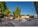 Inviting pool area with waterfall feature and outdoor kitchen at 7736 W Acoma Dr, Peoria, AZ 85381