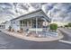 Inviting exterior of a manufactured home with landscaped yard and covered porch at 7750 E Broadway Rd # 584, Mesa, AZ 85208