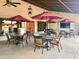 Outdoor patio area with tables and chairs under umbrellas at 7750 E Broadway Rd # 584, Mesa, AZ 85208