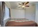 Spacious bedroom with a ceiling fan and built-in closet at 7750 E Broadway Rd # 674, Mesa, AZ 85208