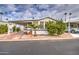 Single-wide manufactured home with carport and nicely landscaped front yard at 7750 E Broadway Rd # 674, Mesa, AZ 85208