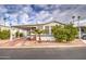 Mobile home with carport, mature landscaping, and citrus trees at 7750 E Broadway Rd # 674, Mesa, AZ 85208