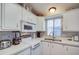 Bright kitchen with white cabinets, quartz countertops, and microwave at 7750 E Broadway Rd # 674, Mesa, AZ 85208