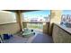 Private balcony with small table and chairs, offering a view of the community at 8344 N 21St Dr # I212, Phoenix, AZ 85021