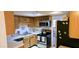 Galley kitchen with wood cabinets, stainless steel microwave and stove at 8344 N 21St Dr # I212, Phoenix, AZ 85021