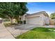 Attached garage with driveway and mature tree in front at 8760 N 73Rd Way, Scottsdale, AZ 85258