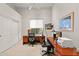 Home office with wood desk, two chairs, and built-in shelving at 8760 N 73Rd Way, Scottsdale, AZ 85258