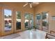 Sunroom with multiple windows, access to backyard, and a ceiling fan at 8760 N 73Rd Way, Scottsdale, AZ 85258