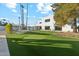 Large backyard with putting green and modern home in background at 9809 E Desert Cove Ave, Scottsdale, AZ 85260