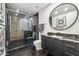 Elegant bathroom with dark vanity, marble countertops, and a large walk-in shower at 9809 E Desert Cove Ave, Scottsdale, AZ 85260