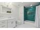 Bathroom with white vanity and green tile shower at 9809 E Desert Cove Ave, Scottsdale, AZ 85260