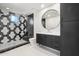 Stylish bathroom with hexagon tile and a round mirror at 9809 E Desert Cove Ave, Scottsdale, AZ 85260