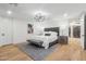 Bright bedroom featuring light wood floors and a neutral color palette at 9809 E Desert Cove Ave, Scottsdale, AZ 85260