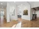 Bright hallway with hardwood floors, high ceilings, and a view of the kitchen and outdoor area at 9809 E Desert Cove Ave, Scottsdale, AZ 85260