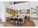 Modern kitchen with marble countertops, light wood cabinets, and a large island at 9809 E Desert Cove Ave, Scottsdale, AZ 85260