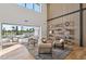 Light-filled living area with sliding doors opening to a patio, showcasing modern furniture at 9809 E Desert Cove Ave, Scottsdale, AZ 85260