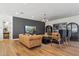 Relaxing living room with leather sofas, wood floors, and large TV at 9809 E Desert Cove Ave, Scottsdale, AZ 85260